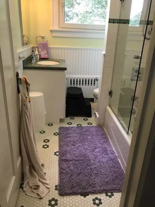 Reviewer photo displaying a purple bath mat placed on a bathroom floor