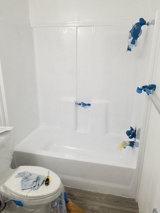 after: the same tub and surrounding area, now gleaming white