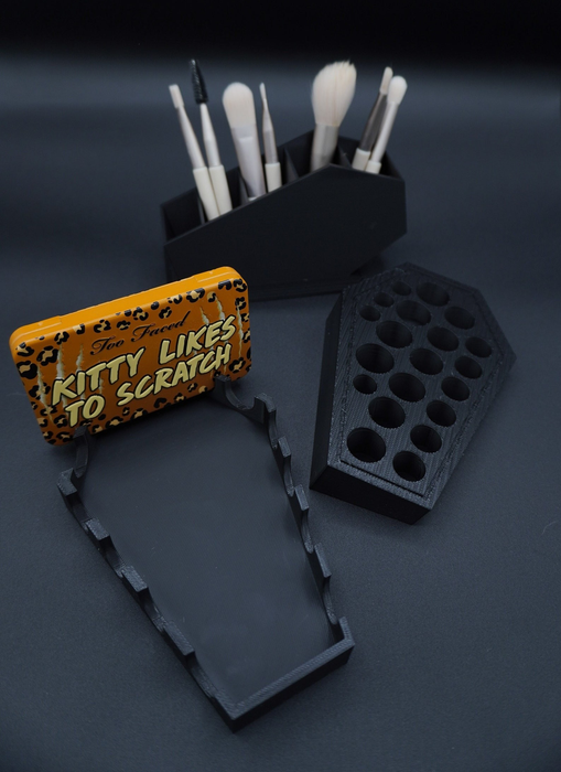 Makeup brush holders and a nail file featuring a fun cat theme, as seen in a shopping article.