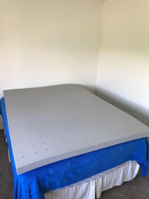 A charcoal mattress topper placed on a bed
