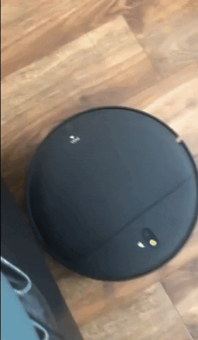 A gif showing the reviewer's vacuum being used on both hardwood and carpet surfaces.