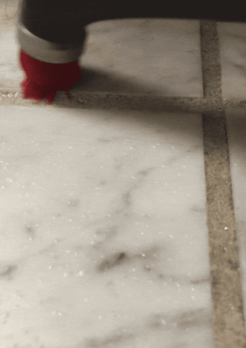 A gif of a Mytour Shopping reviewer cleaning grout with the power scrubbing brush.