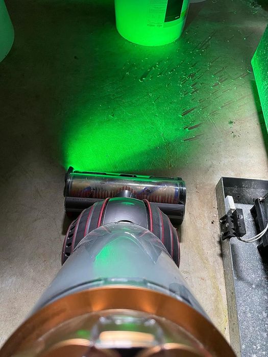 A reviewer showcasing the LED light attached to their Dyson vacuum cleaner
