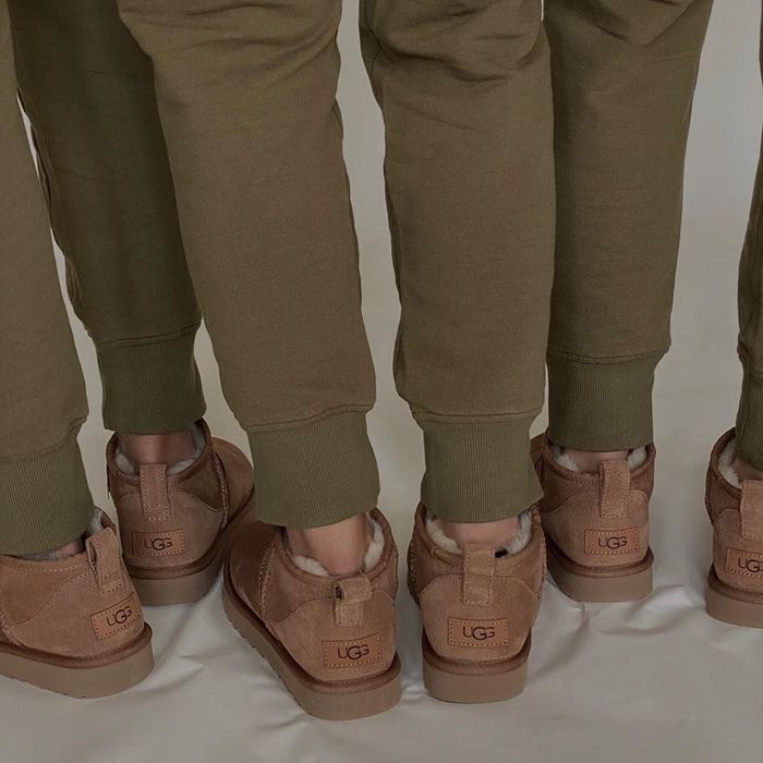 Three models showcasing the back view of the Ugg boots