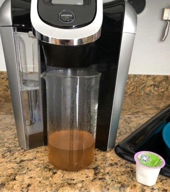 A reviewer shows a photo of the dirty liquid that was removed from the Keurig with the cleaning pod