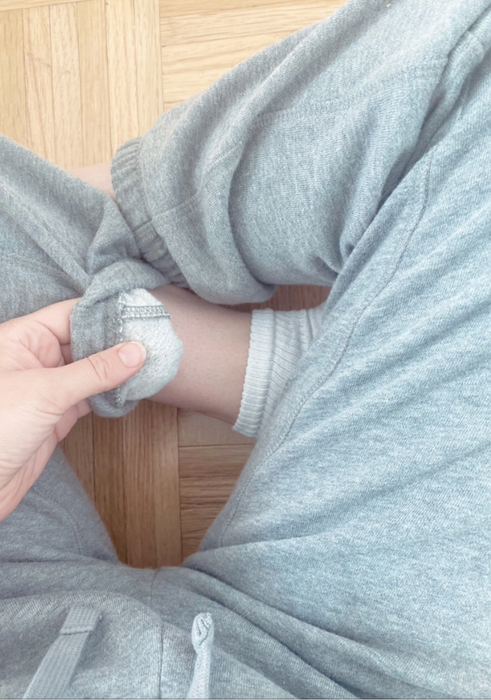 Close-up of the bottom of the sweatpants turned slightly inside out to show the soft fabric on the inside