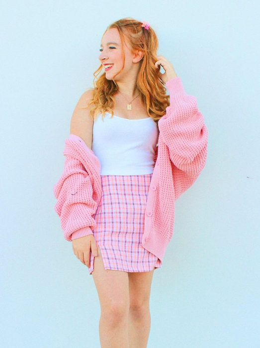 Reviewer showcasing the cardigan in pink