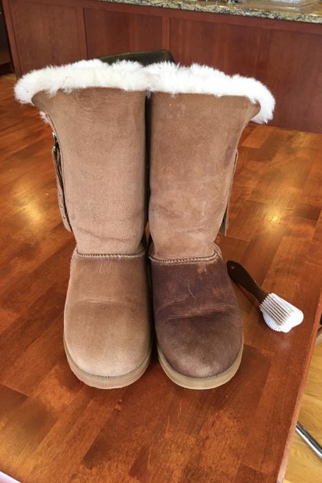 A reviewer shows their Ugg boots after using the brush, revealing the difference it makes.