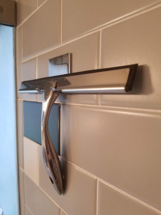 A close-up shot of the silver squeegee in action