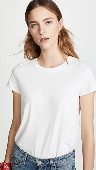 A front view of a model wearing the white tee