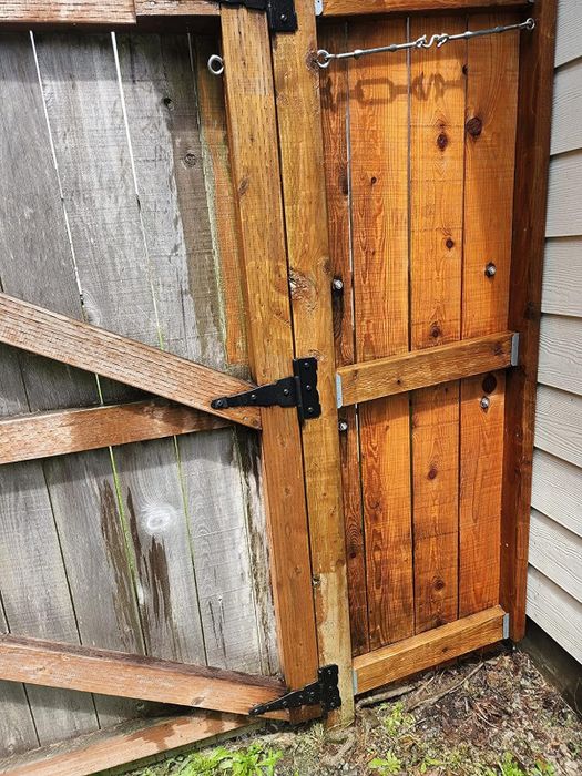 A reviewer's fence shown before and after using the pressure washer