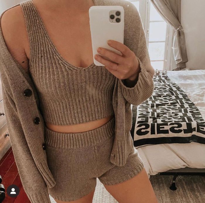 A reviewer wearing the sweater tank in a mushroom hue
