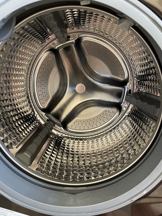 A reviewer showcasing their freshly cleaned washing machine