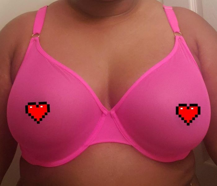 A reviewer sporting a pink mesh bra.
