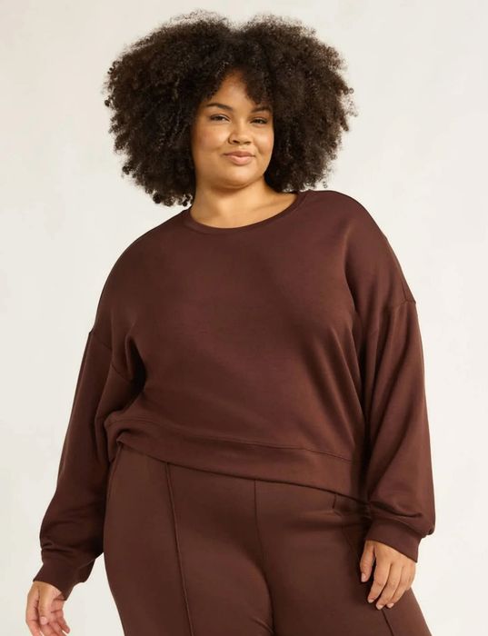 A person lounging comfortably in a cozy, relaxed-fit lounge set, perfect for casual wear, highlighted in a shopping feature.