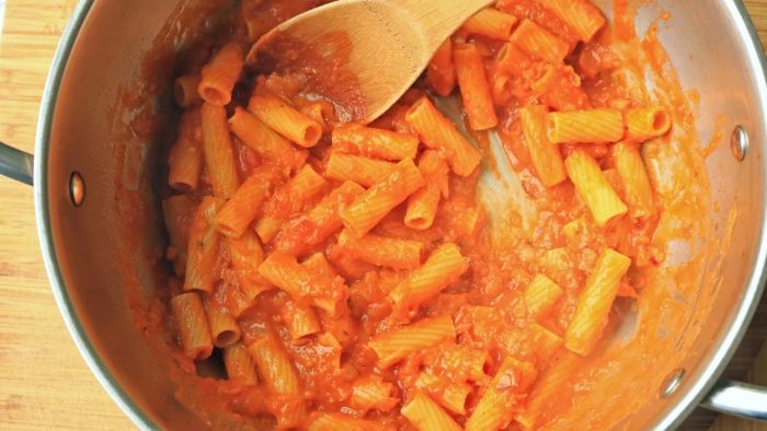 A pot filled with penne and vodka sauce.