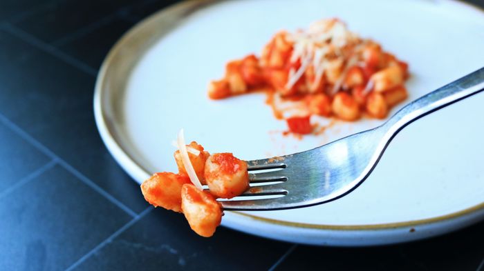 A fork with a bite of gnocchetti.