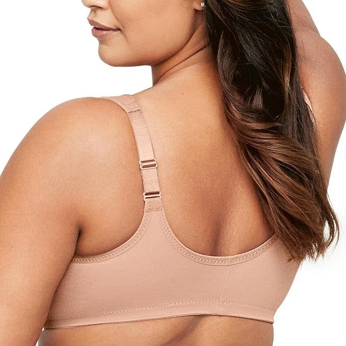 The model is wearing a beige wireless bra that highlights adjustable straps and smooth fabric across the back.