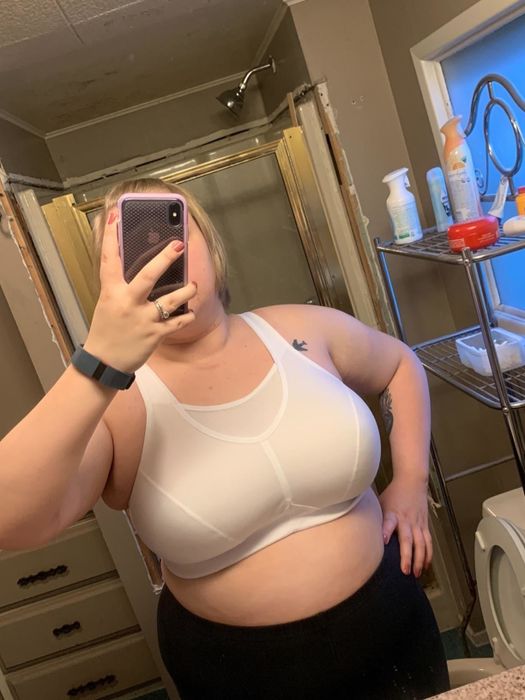 A model wearing the same sports bra style in a white color.