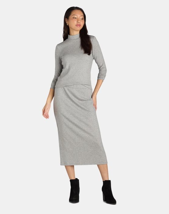 A model showcasing a grey matching set, styled for a chic and coordinated look.