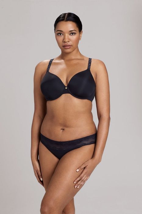 A person modeling a matching black T-shirt bra and underwear set.