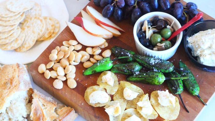 A dinner made up of nuts, fruit, and crackers