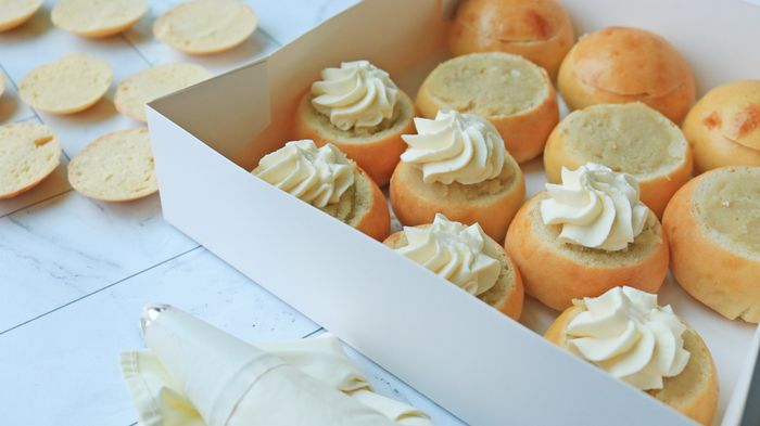 Semlor buns in the filling process.