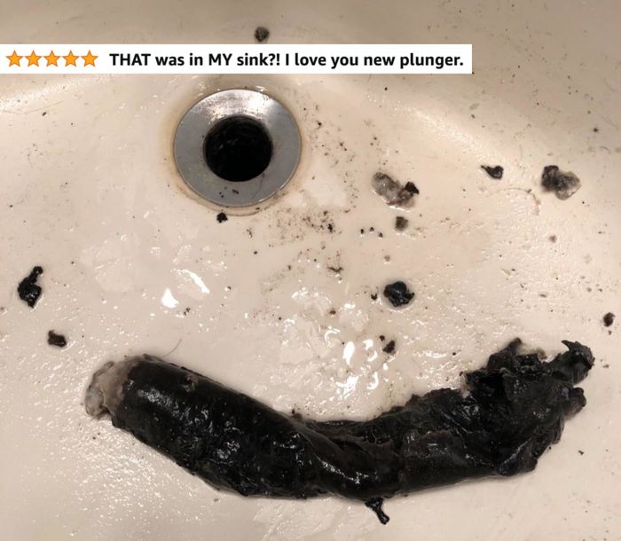 A bathroom sink that has just been unclogged, showing the gunk and debris that came out.
