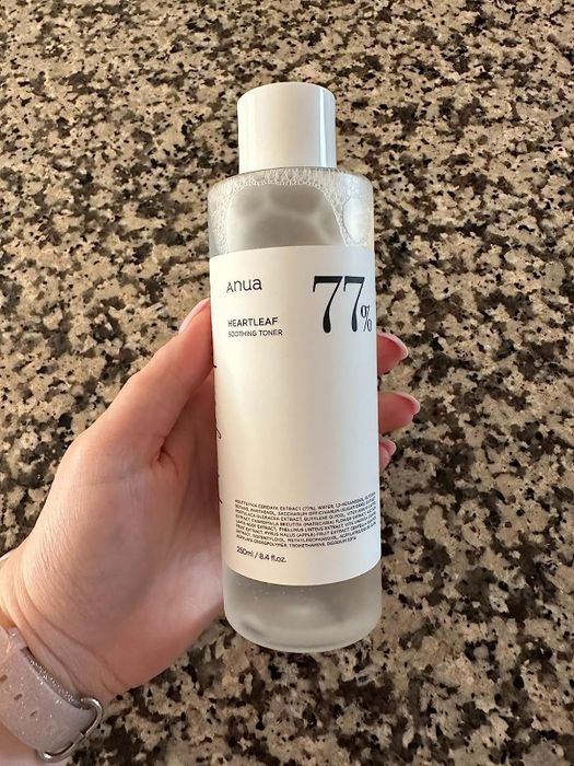 Image of a reviewer holding a bottle of the toner
