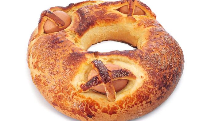 A round loaf of bread with whole eggs baked into it.