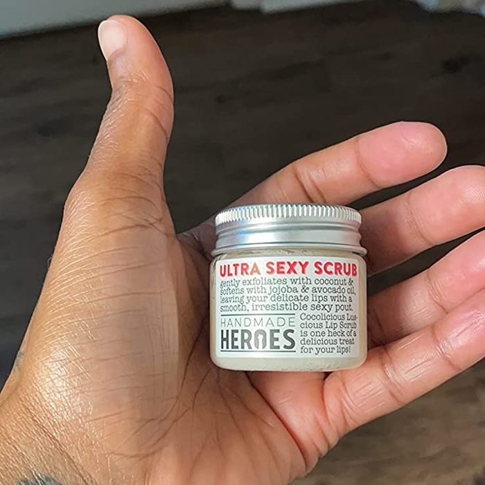 An image showing the small jar of lip scrub resting in a reviewer's hand