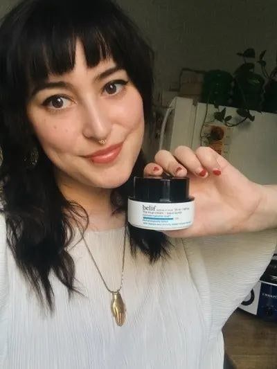 Mytour writer holding the jar of moisturizer