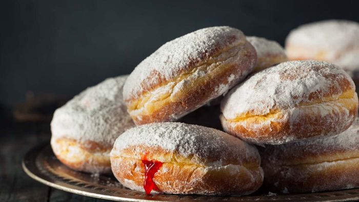 A jelly-filled doughnut resting on a plate