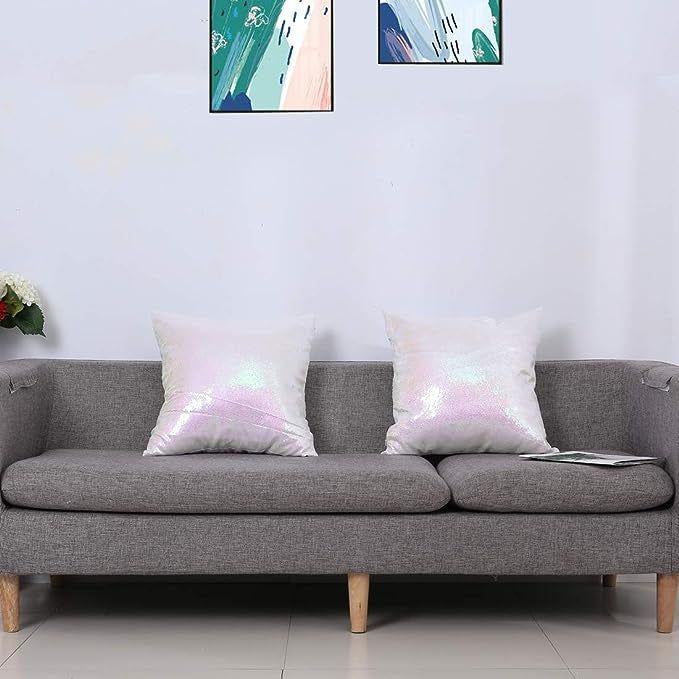 The shimmering pillows displayed on a grey couch.