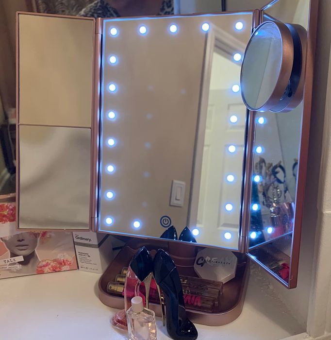 A pink vanity mirror from the reviewer, open and illuminated.