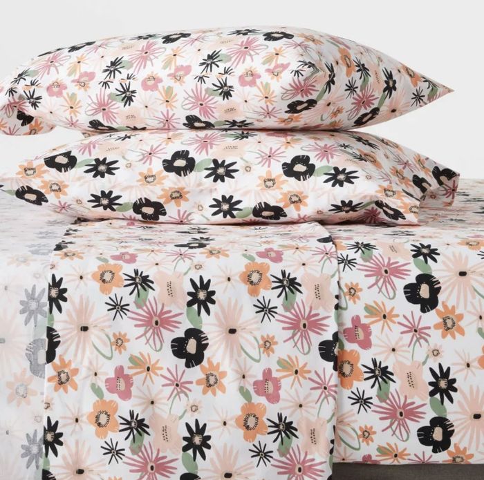 A set of floral-patterned bed sheets.