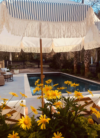 A photo from the reviewer showing the umbrella by the pool.