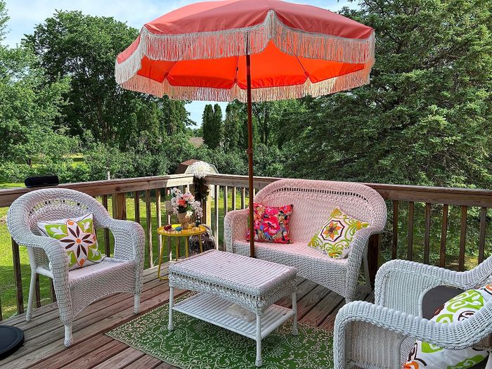 The reviewer's coral pink umbrella set up on the patio.