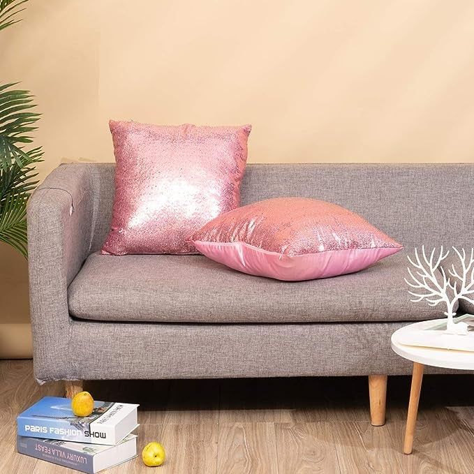 The pink pillows placed on a grey couch.