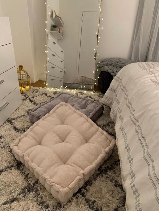 The chic white and grey floor pillows stacked together.