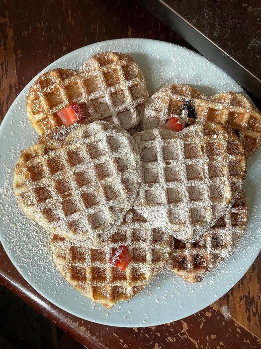 The reviewer's photo showing a plate filled with heart-shaped waffles