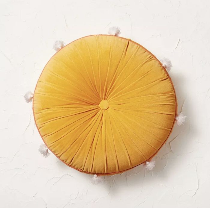 A yellow oversized floor pillow