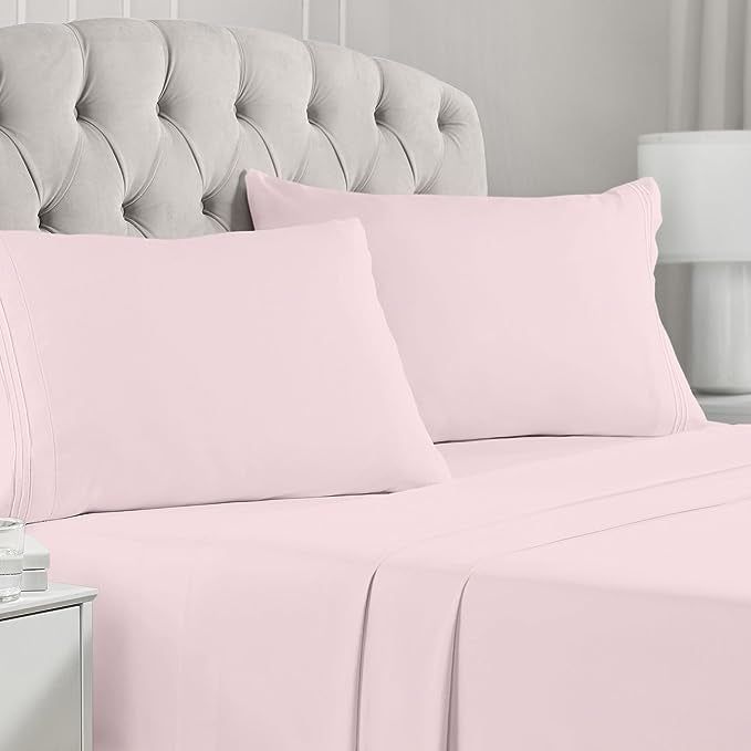 The pink four-piece sheet set placed neatly on a bed