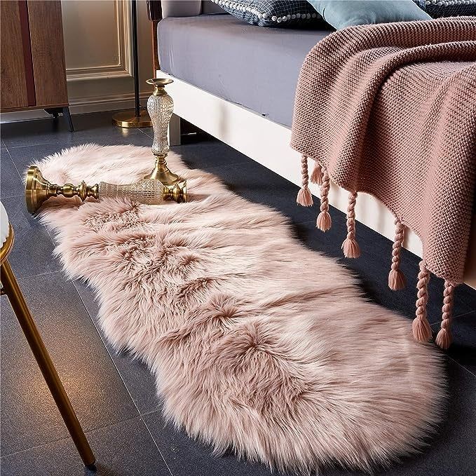 Pink rug placed beside a bed