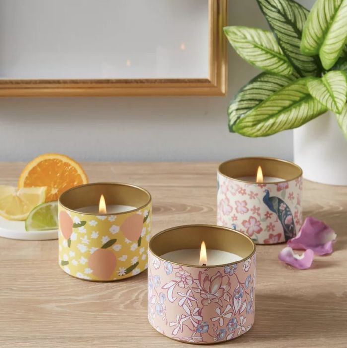 A set of three tin-wrapped scented candles