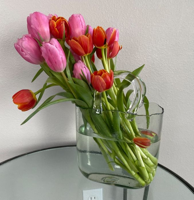 The reviewer's light blue vase filled with tulips