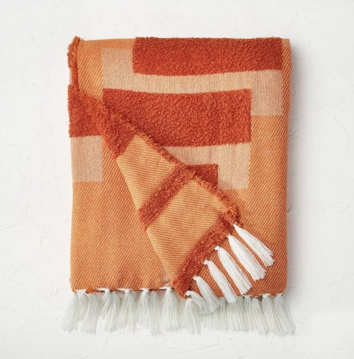 An orange, chunky woven throw blanket