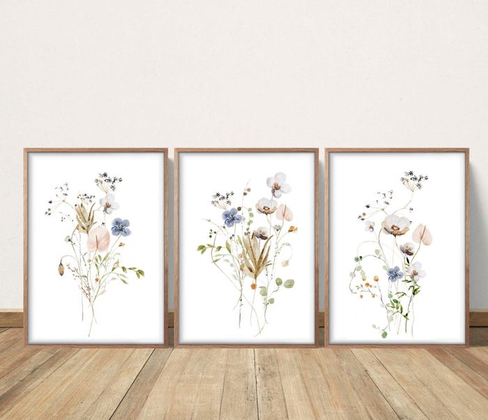 Three paintings featuring soft pastel flowers set against a white backdrop.