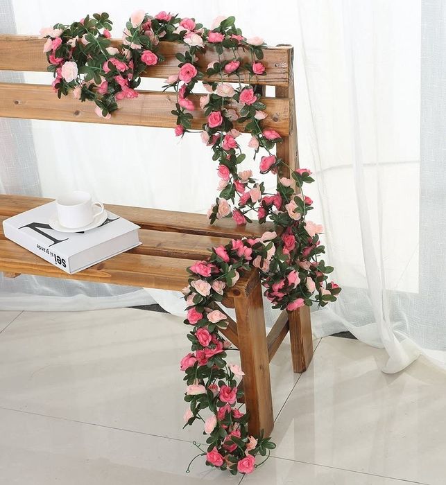A garland draped over an indoor bench.