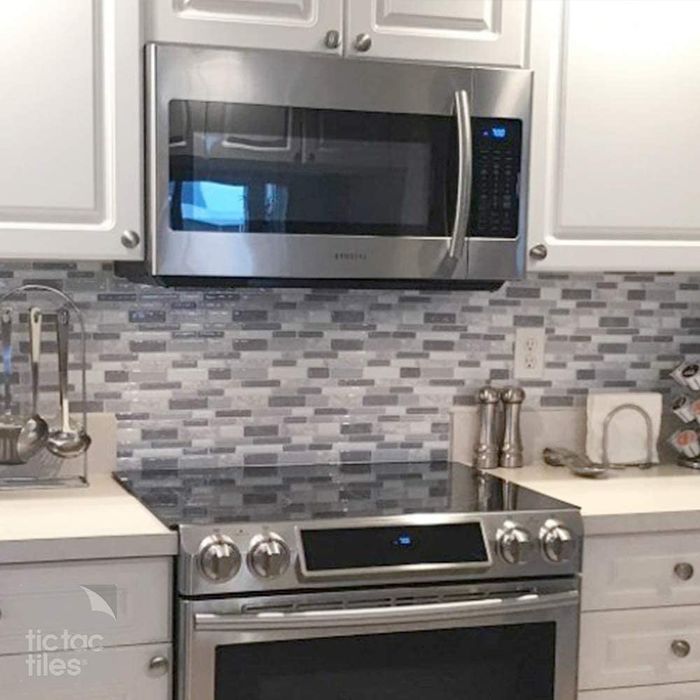 A kitchen featuring a tiled backsplash installed on the wall